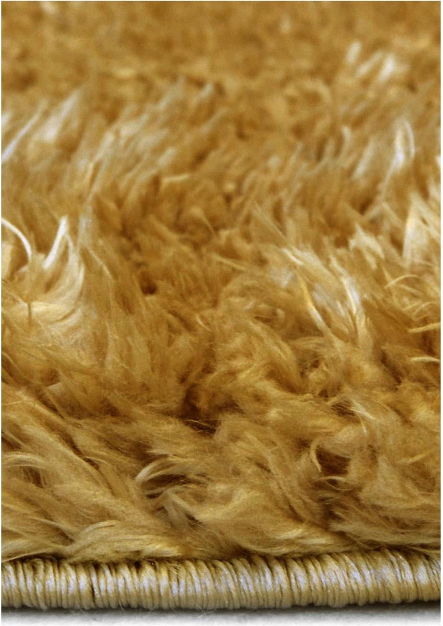 A plush lagom ochre shaggy rug with dense soft texture and neatly finished edge in golden brown tones