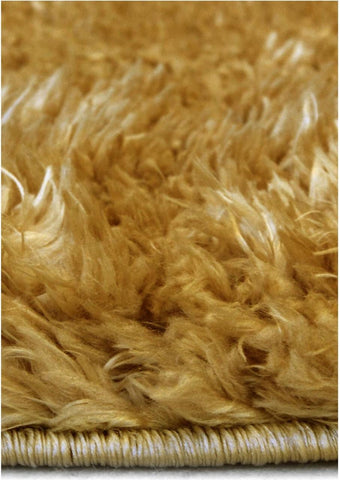 A plush lagom ochre shaggy rug with dense soft texture and neatly finished edge in golden brown tones