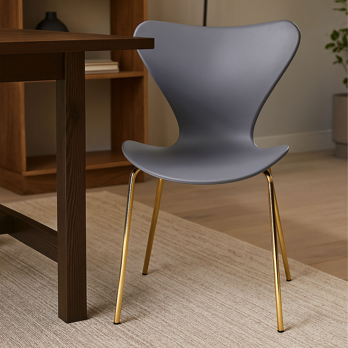 Laila dining chair with grey seat featuring a gray plastic seat and gold metal legs for stylish dining areas