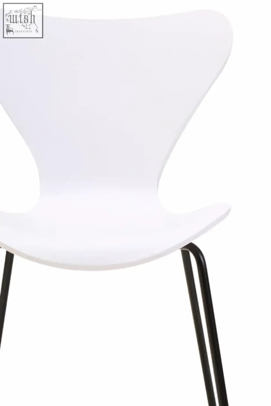 White molded plastic dining chair with sleek black angular legs and a white undulating seat design