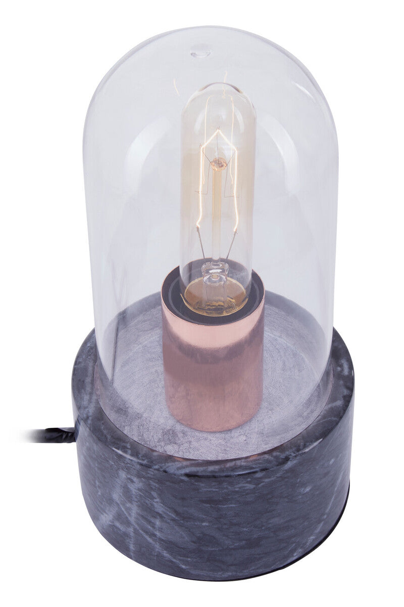 A sleek lamonte bell lamp with a clear glass dome and black marble base featuring an exposed filament bulb