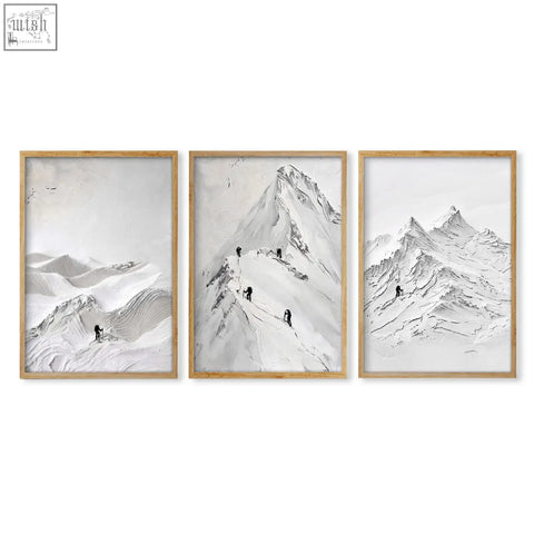 Set of three minimalist black and white landscape art prints featuring nordic mountain climbers with light wood frames wall art