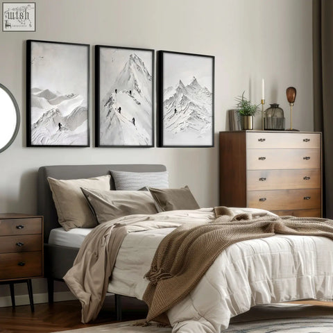 Three black-framed minimalist nordic mountain climbers landscape art prints hung above the bed as wall art