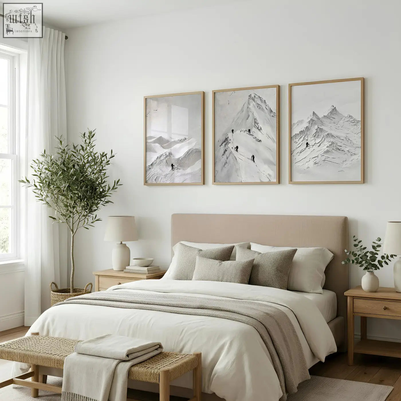 Beige upholstered bed with matching pillows and neutral throw blanket below landscape art nordic mountain climbers wall art prints set of 3