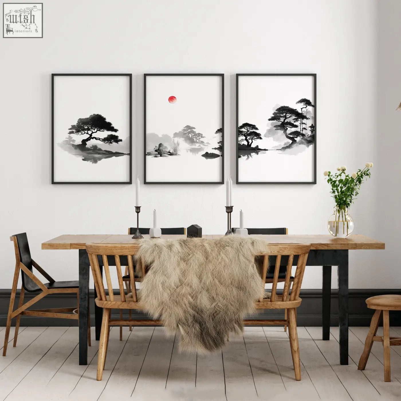 Three framed japanese ink landscape art paintings with red sun displayed above a wooden dining room table
