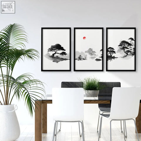 Three black-framed japanese ink zen bonsai landscape art paintings with red sun displayed above a dining room table