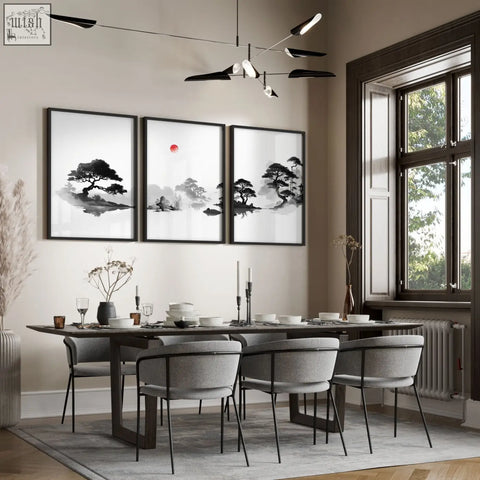 Three framed black and white landscape art paintings of japanese ink pine trees and mist hang above a dining room table