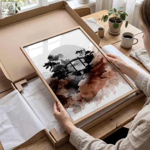 A framed landscape print of japanese ink wash art featuring a black ink bridge over brown and gray abstract waters