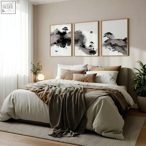 Three framed black and white japanese ink wash landscape prints with maroon moon and pine trees above bed