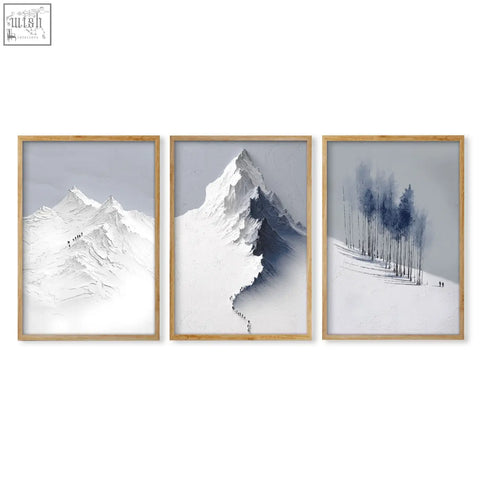 Set of 3 minimalist landscape wall art prints featuring snowy nordic mountains and winter forest scenes in muted tones