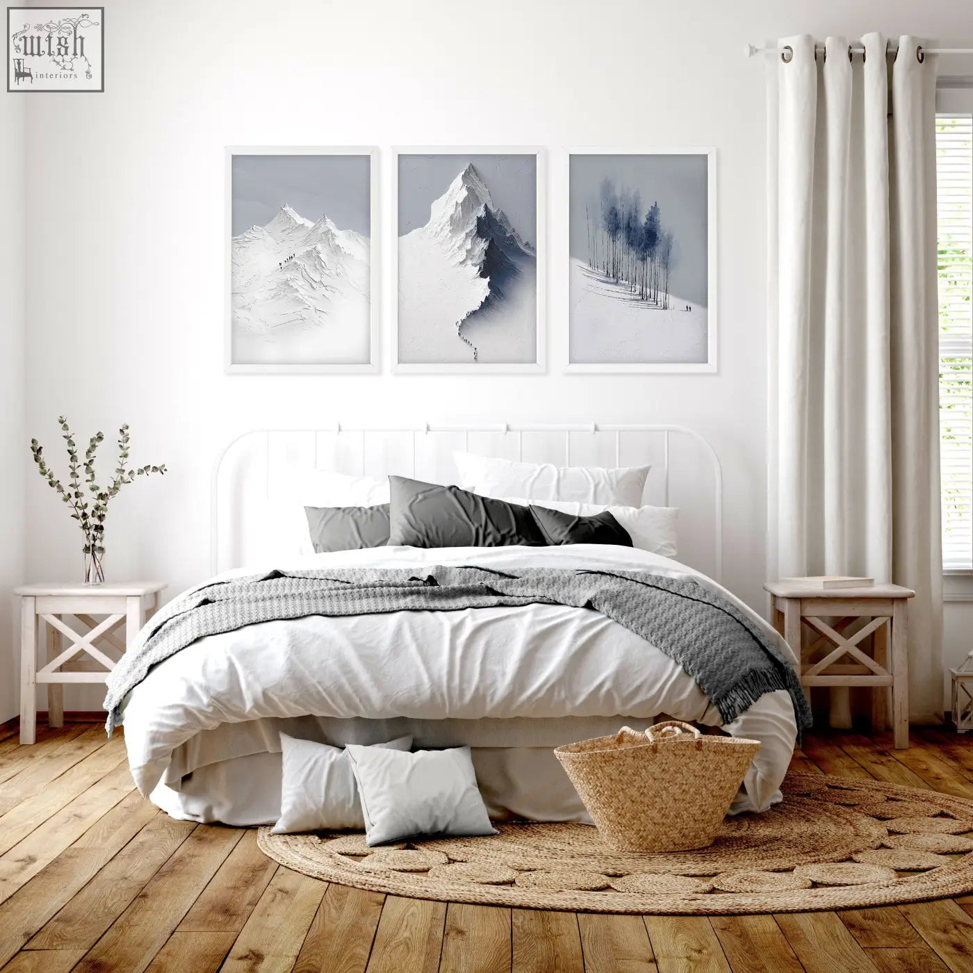 White metal bed frame with curved headboard and matching nightstands below nordic snow mountains landscape wall art set