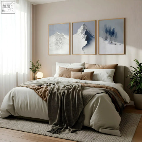 Cozy bed with soft beige and brown bedding and gray throw featuring nordic snow mountains landscape wall art set of 3