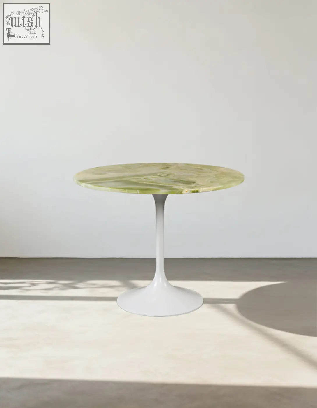 Langenfeld round dining table with a sleek green marble top and minimalist white pedestal base perfect for round dining