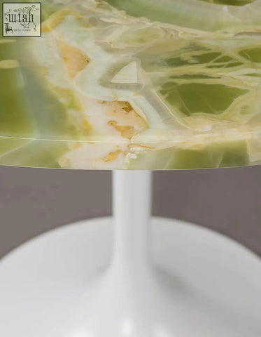 Langenfeld round dining table with a sleek translucent green and white onyx marble top and minimalist white pedestal base