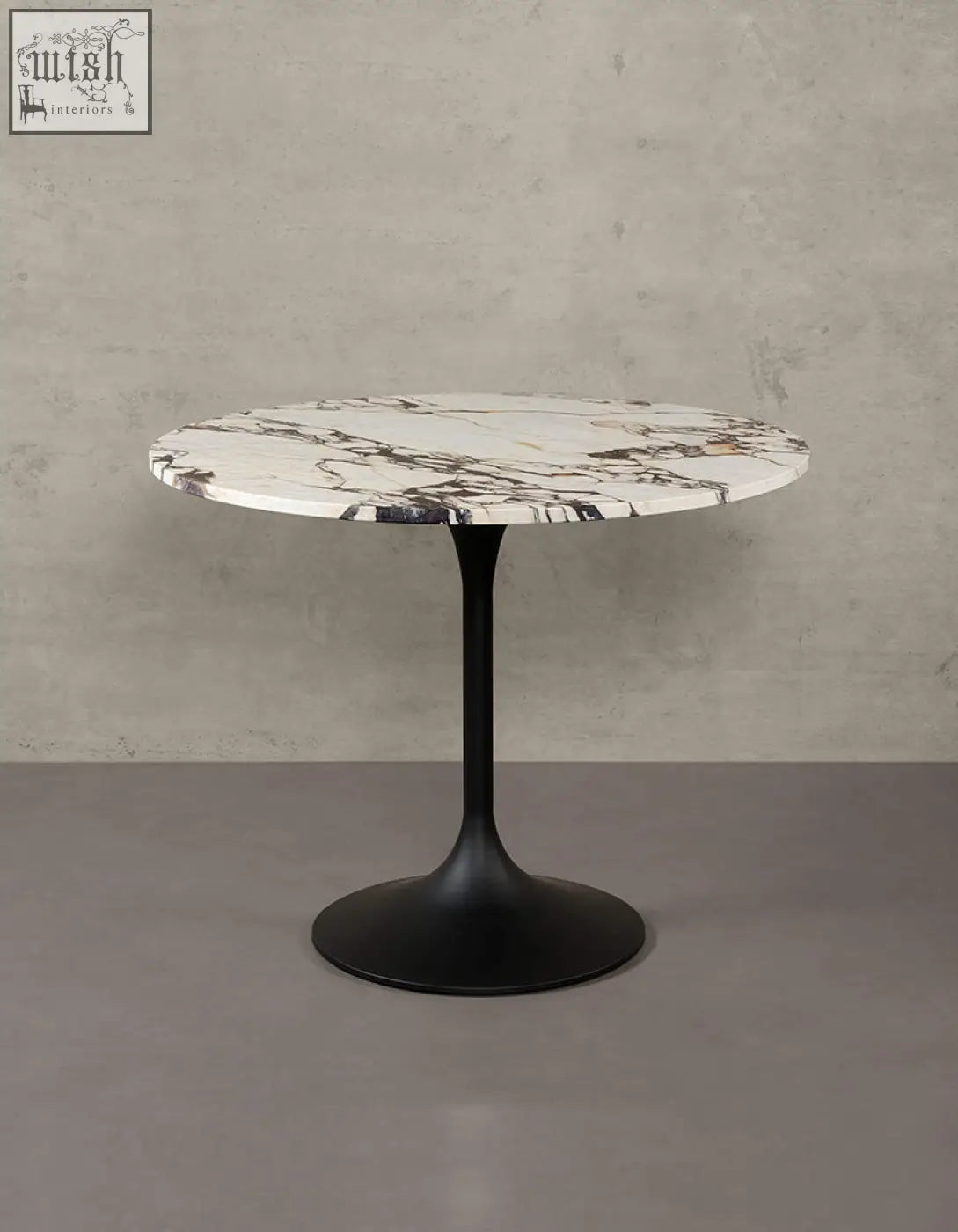 Langenfeld round dining table with a white marble top and matte black metal pedestal base perfect for dining rooms