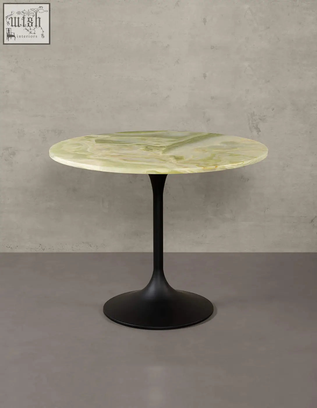 Langenfeld round dining table featuring a pale green marble top and matte black metal pedestal base for round dining