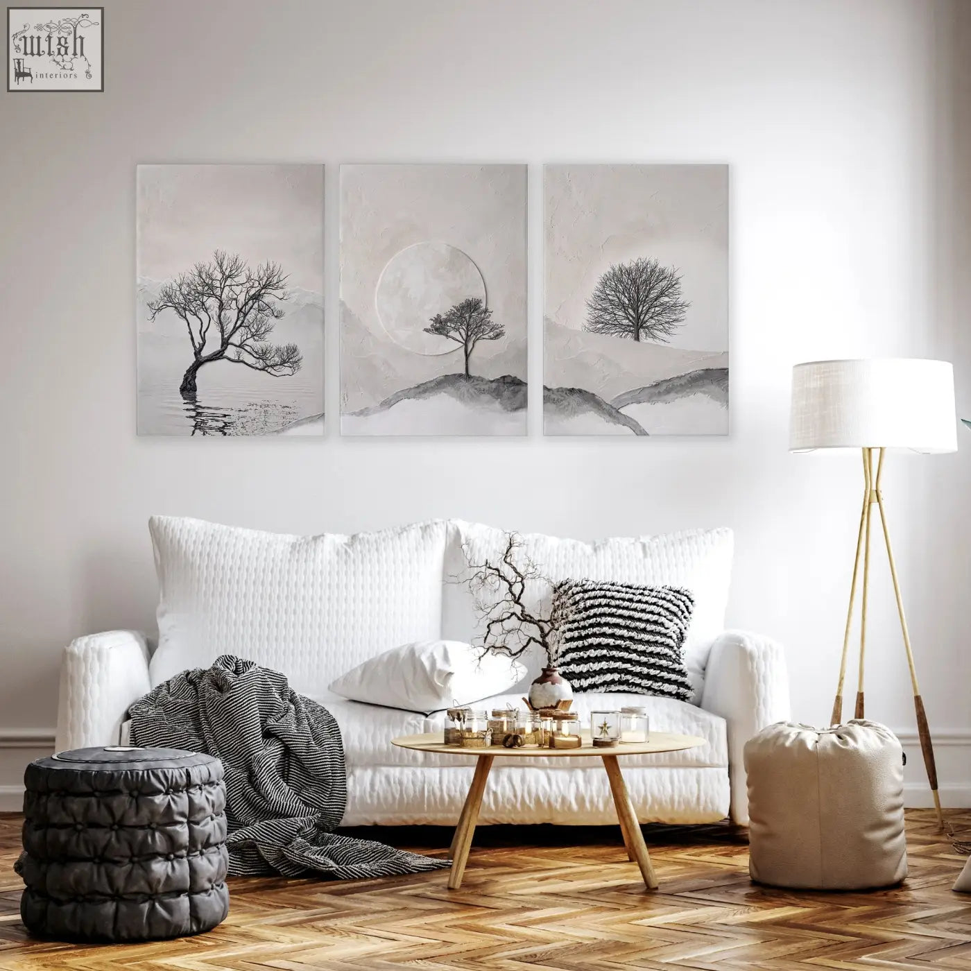 Large 3 piece black and white minimalist wall art featuring solitary trees for living room decoration above white sofa