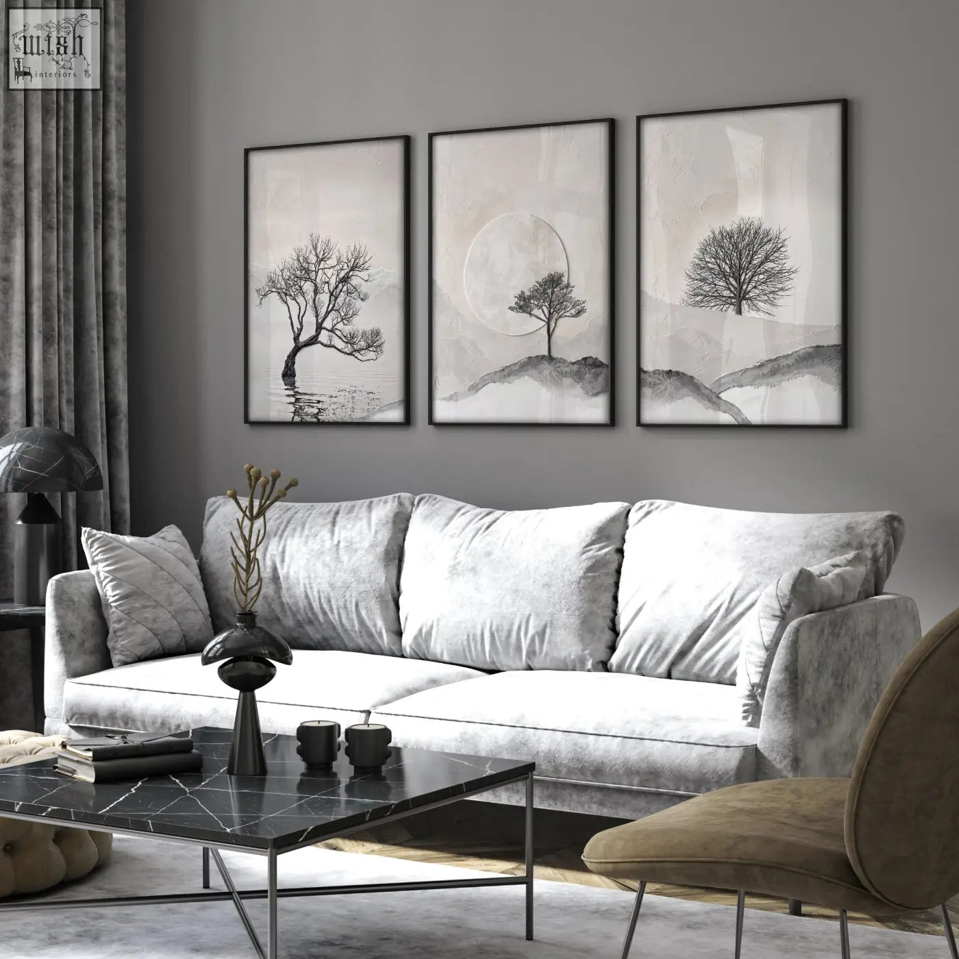 Gray velvet sofa with white cushions in living room featuring large 3 piece wall art of scandinavian trees and moon landscape
