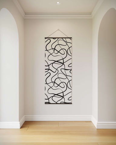 Large abstract wavy black line art wall hanging with minimalist design suspended by thin wire as wavy line tapestry