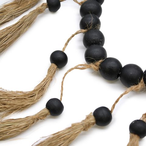 Large bead heart mobile with black wooden beads strung on natural jute twine and finished with matching tassels