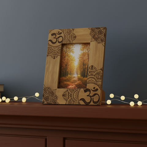 A light brown mango wood photo frame 13x18cm with dark mandala and ohm designs showing autumn forest path