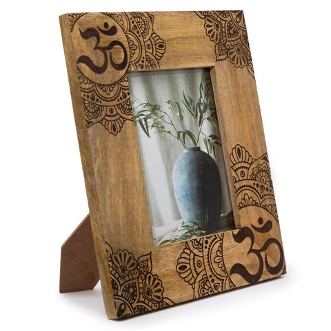 A large black ohm mandala mango wood photo frame 13x18cm with intricate dark brown patterns and natural wood grain finish