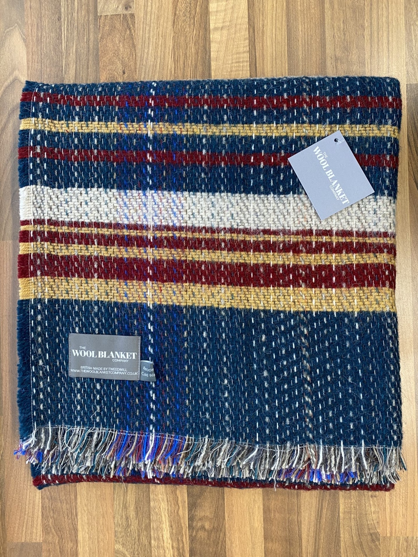 Cozy large checked random recycled wool blanket with bold navy blue red cream mustard stripes and multicolored fringe