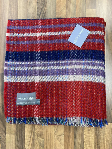 A cozy large checked random recycled wool blanket with bold red navy and white stripes and textured fringe