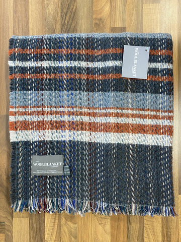 A cozy large checked random recycled wool blanket with navy blue gray orange and white plaid and fringed edges