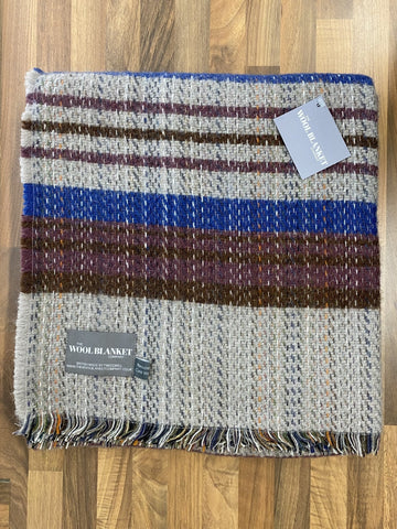 A cozy large checked random recycled wool blanket with gray blue burgundy and brown stripes and fringed edges