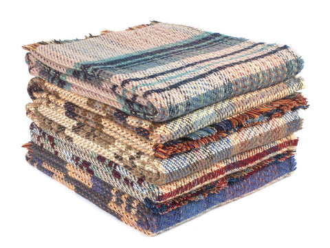 Stack of large checked random recycled wool throw blankets with frayed edges and earthy multicolored stripes