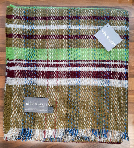A large checked random recycled wool blanket with a plaid pattern in green maroon white and blue shades