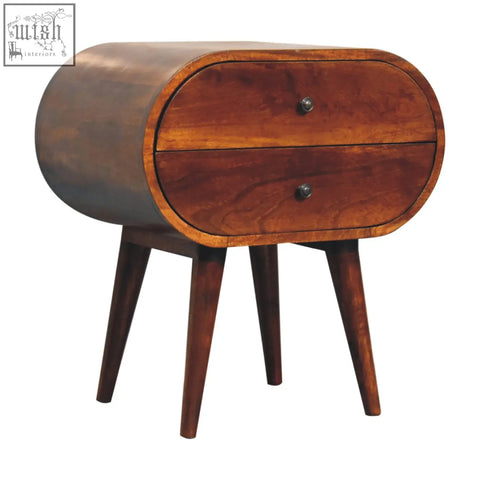 Large chestnut circular bedside table with two drawers made of dark wood and tapered legs in mid-century modern style