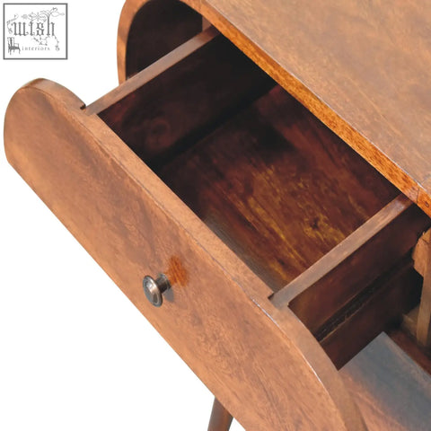 Large chestnut circular bedside table with warm medium brown wood and curved drawer front with silver knob