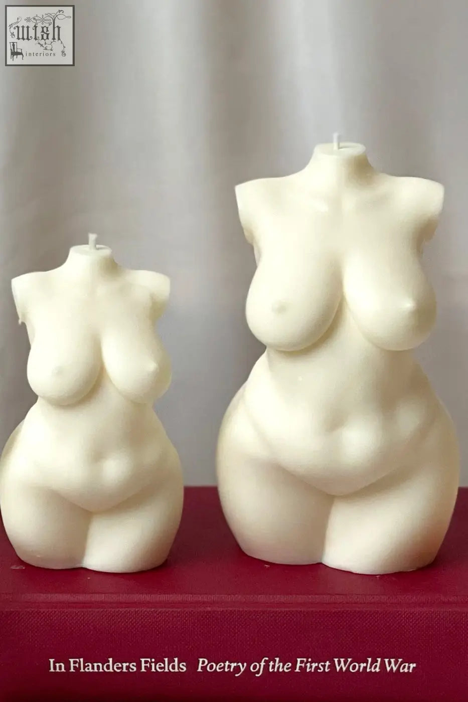 Cream-colored smooth curvy body candle shaped like a large female torso with detailed sculpted curves