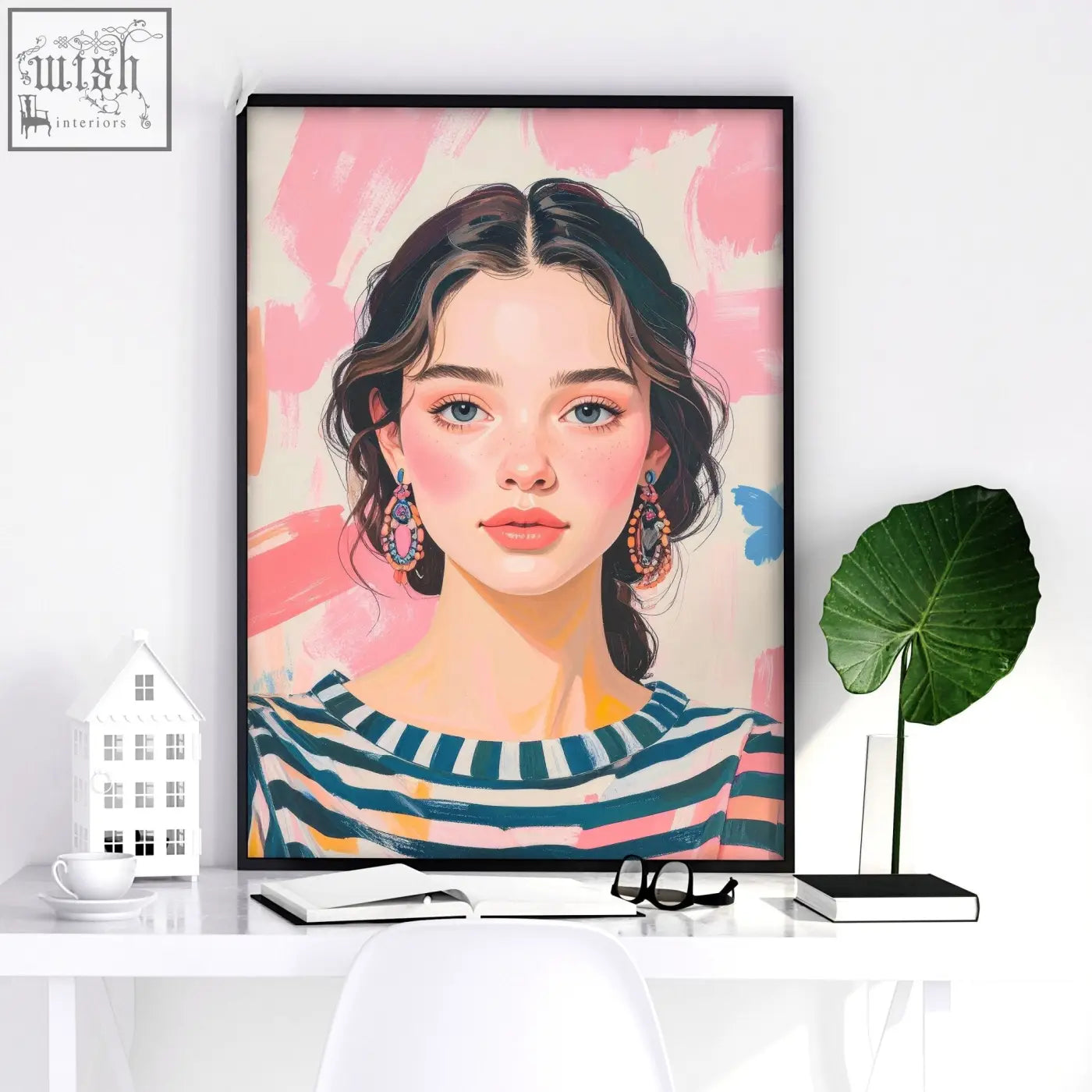 A large framed picture wall art featuring a woman with dark hair and colorful stripes on a soft pink background
