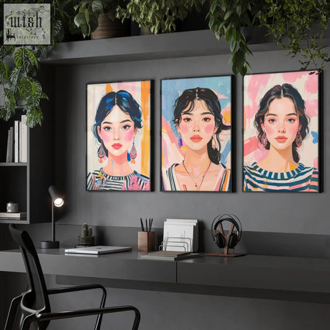 Three large framed pictures of boho women wall art prints with colorful backgrounds hanging on a dark gray wall