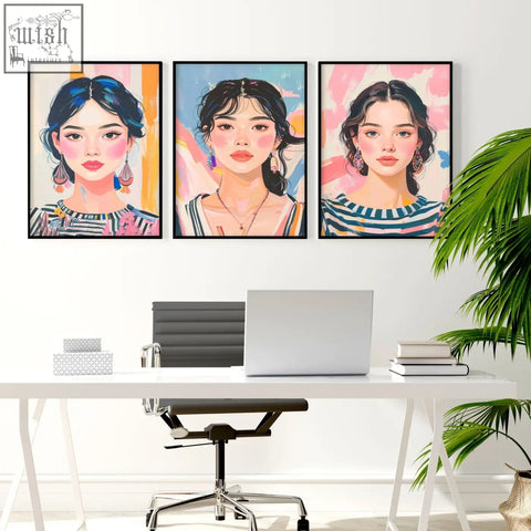 Three large framed pictures of boho women with colorful backgrounds hang as wall art above a white desk