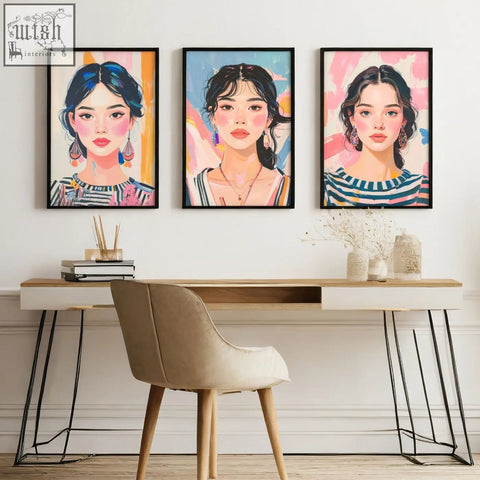 Three large framed pictures featuring boho women with vibrant colorful backgrounds hang as wall art above a modern desk