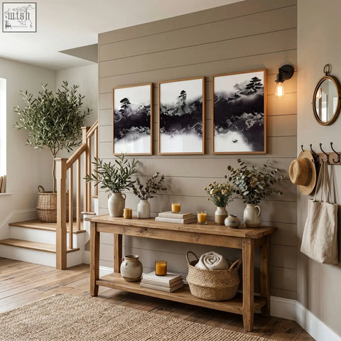 Rustic wooden console table with shelves holding vases and books below large japanese wall art misty ink landscape set of 3