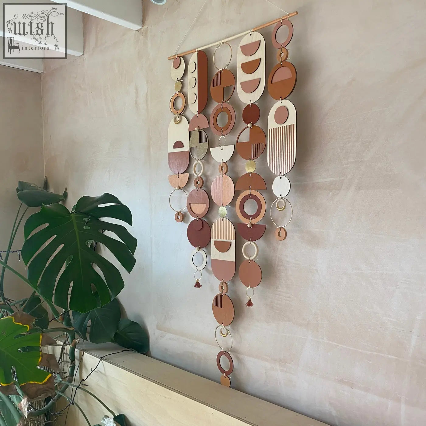 Large modern wall art featuring layered wooden and metal geometric pieces in warm terracotta beige and gold tones