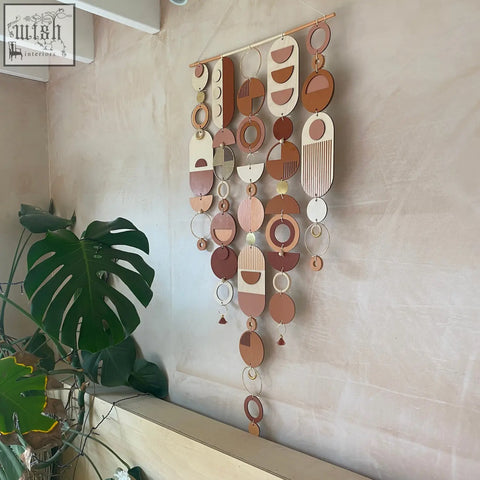 Large modern wall art featuring layered wooden and metal geometric pieces in warm terracotta beige and gold tones