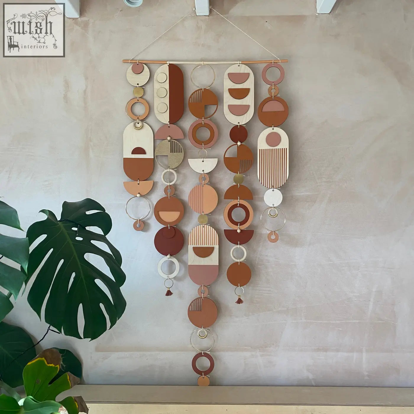 Large modern wall art featuring layered wooden and metal geometric pieces in warm terracotta beige and cream tones