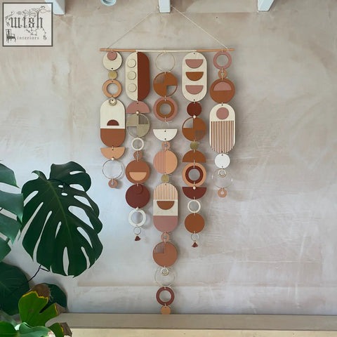 Large modern wall art featuring layered wooden and metal geometric pieces in warm terracotta beige and cream tones