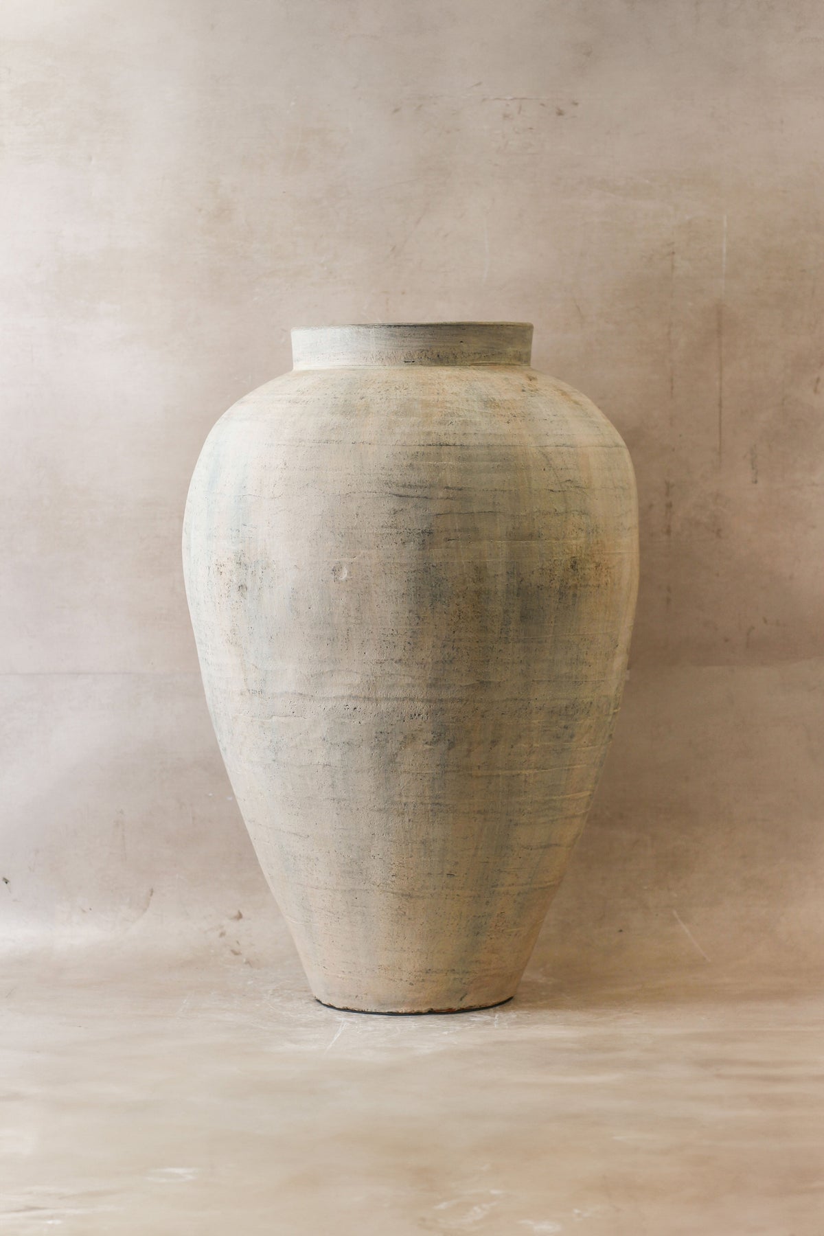 A tall matte off-white ceramic vase with subtle texture large neutral rustic indonesian pot no 23