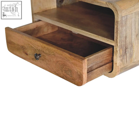 A large oak-ish curve upper slot floating bedside table in rustic mango wood with drawer and dark metal knob