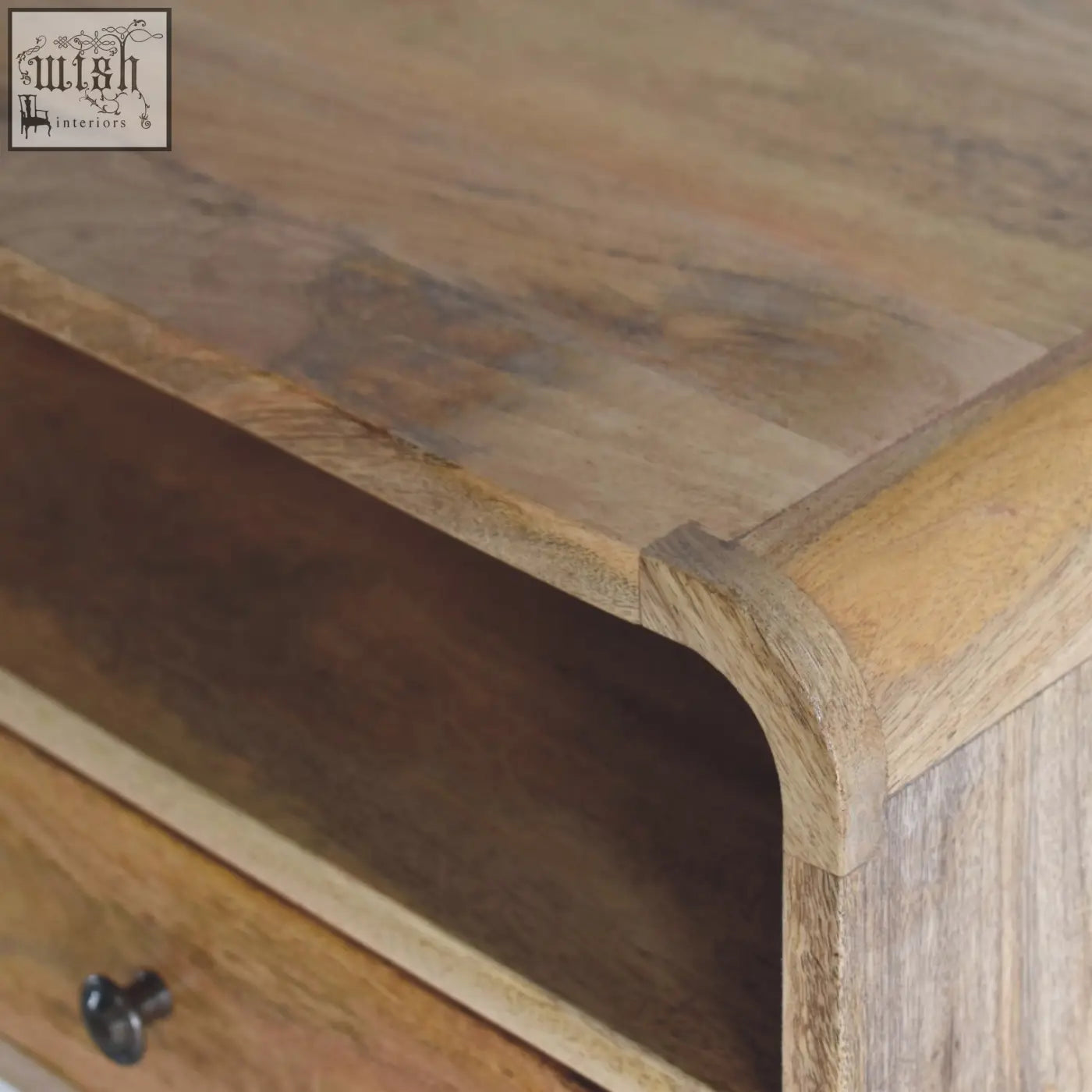 A rustic large oak-ish curve upper slot floating bedside table in warm mango wood with natural grain patterns