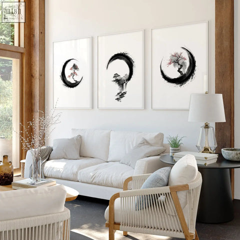 Three black-and-white ink wash art prints of trees in crescent moons hung above white sofa for living room large painting