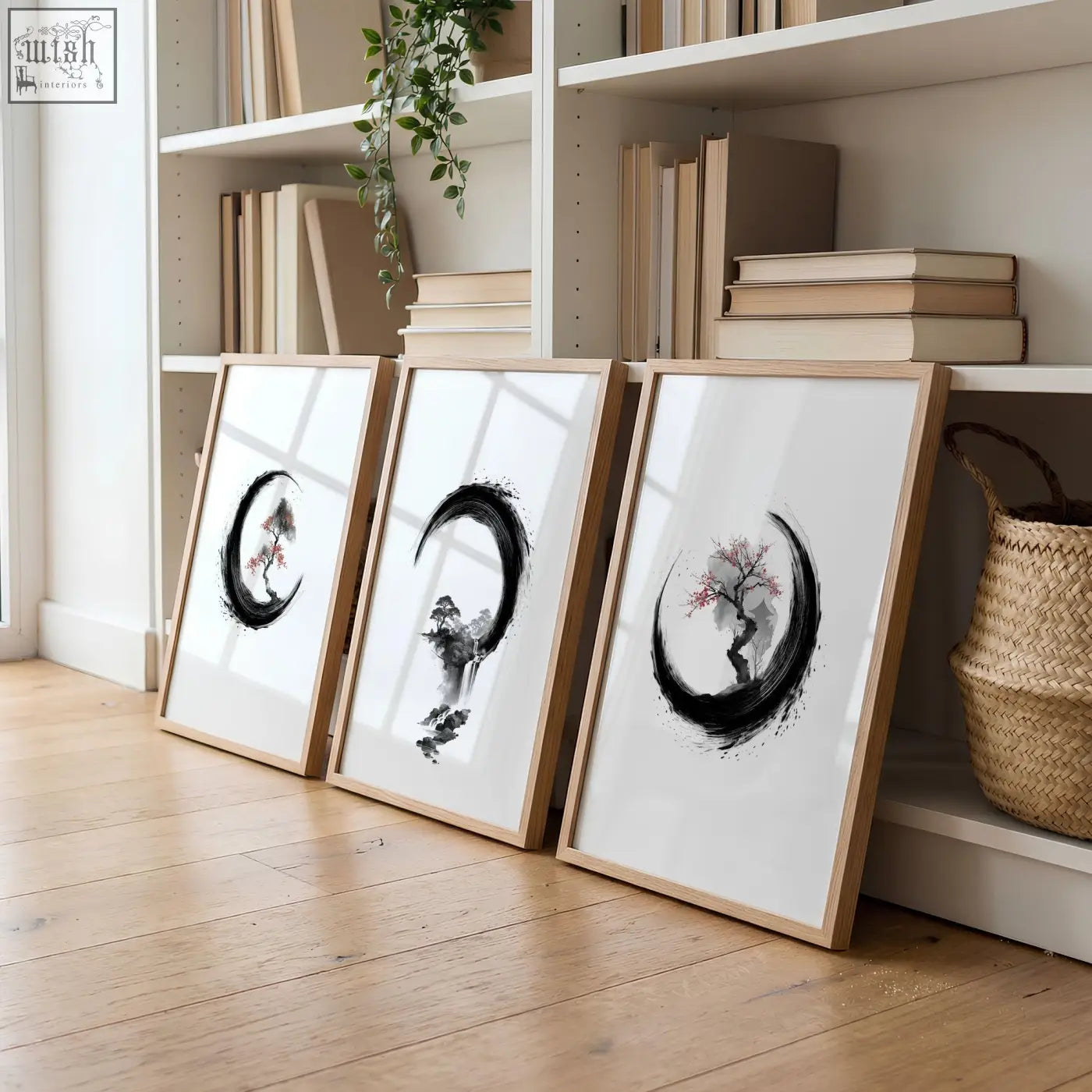 Three large ink wash art prints with black crescent moons and cherry blossoms in light wood frames for living room