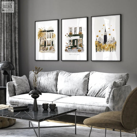 Gray velvet sofa with white cushions and black marble coffee table under large autumn in new york living room wall art set